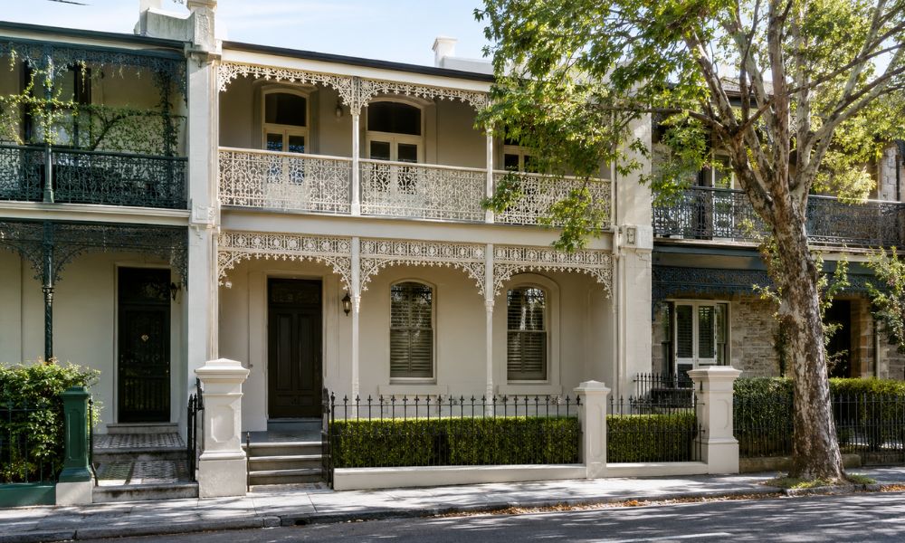 Restored Victorian terrace facade with iron lacework repainted in a heritage colour scheme