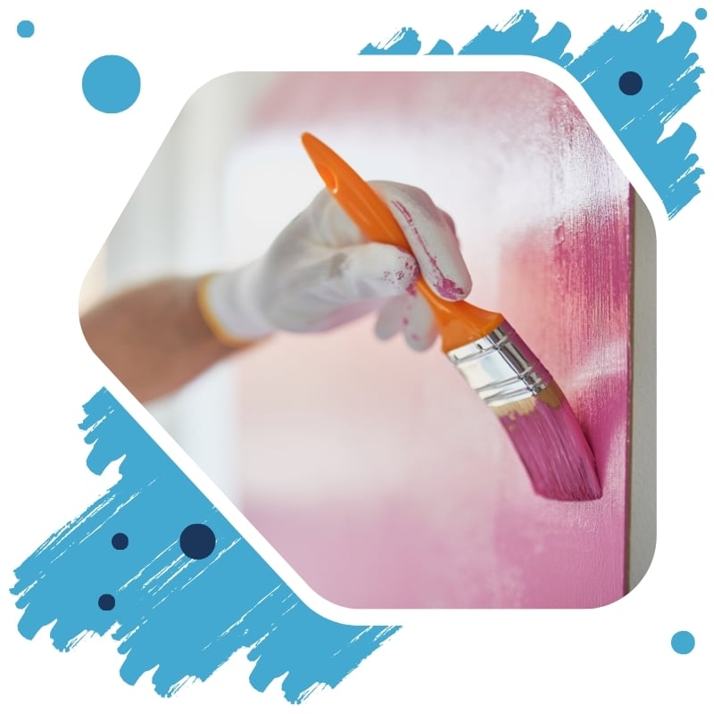 Professional painters in Inner West applying pink paint to a wall with a brush, showcasing precision and quality work.