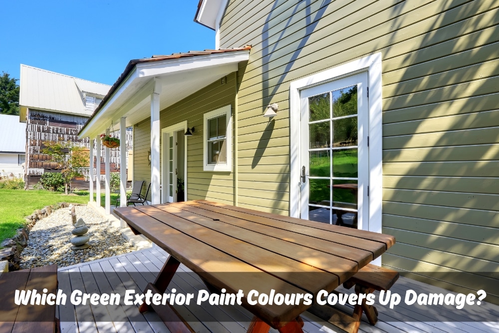 Image of a large house with a green exterior paint colour and a driveway leading up to it.