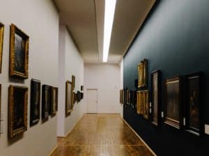 Gallery-style hallway with dark and light walls, showcasing how to choose the right paint colour for a dark hallway.