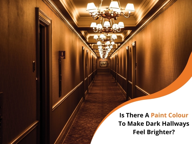 Dimly lit hallway with chandeliers and dark walls, seeking the best paint colour for a dark hallway.