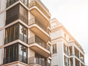 Modern apartment building with balconies, demonstrating how painting outdoor walls enhances aesthetics and prevents damage.