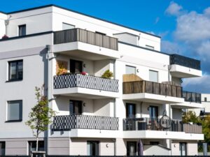 Bright apartment complex, showcasing how painting outdoor walls protects strata buildings from wear and weather damage.