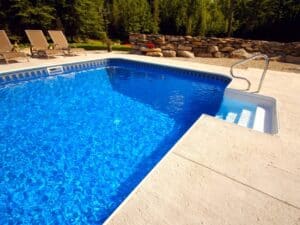 A clean, blue fibreglass pool after repainting, showing the smooth finish and water clarity.