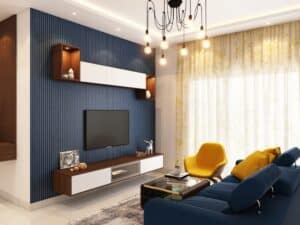 A stylish living room with blue accent walls, a yellow chair, and warm lighting, featuring paint colours for small rooms.