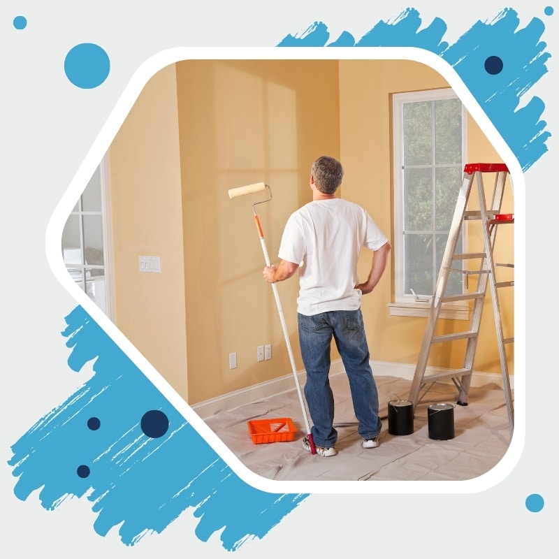 Reliable Painting Company in Sydney repainting interior walls with roller, ladder, and paint supplies in view.