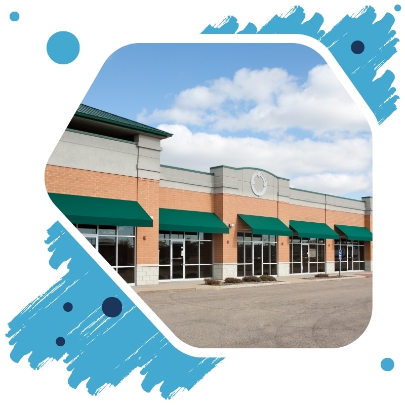 Freshly painted retail plaza with green awnings showing professional commercial painting in Sydney for modern curb appeal.