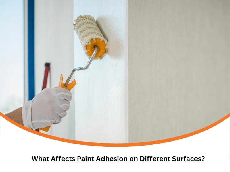 Worker using roller on wall to ensure smooth paint adhesion during interior painting.