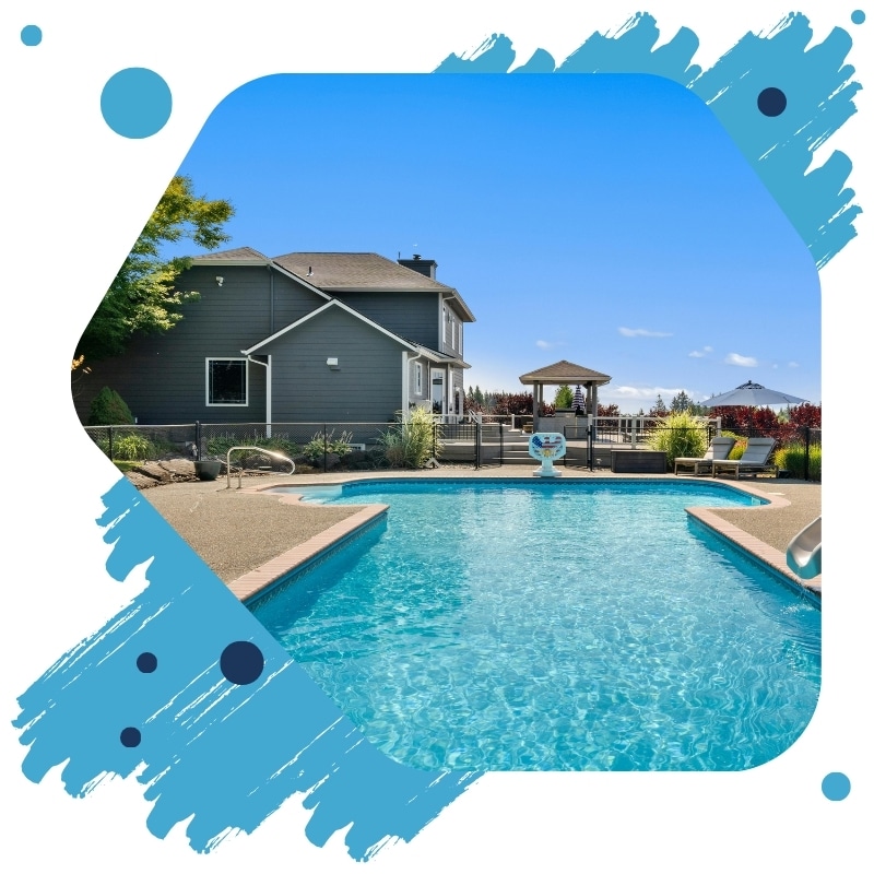 A freshly painted swimming pool in Sydney with clear blue water beside a modern home and outdoor seating.