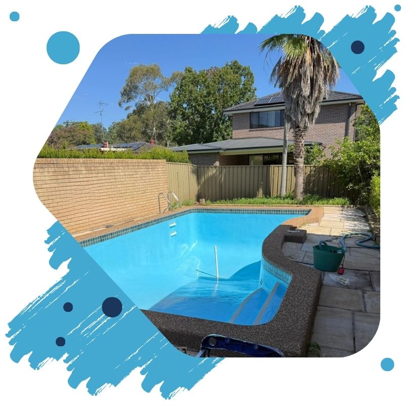 A freshly painted swimming pool in Sydney with clear blue water beside a modern home and outdoor seating.