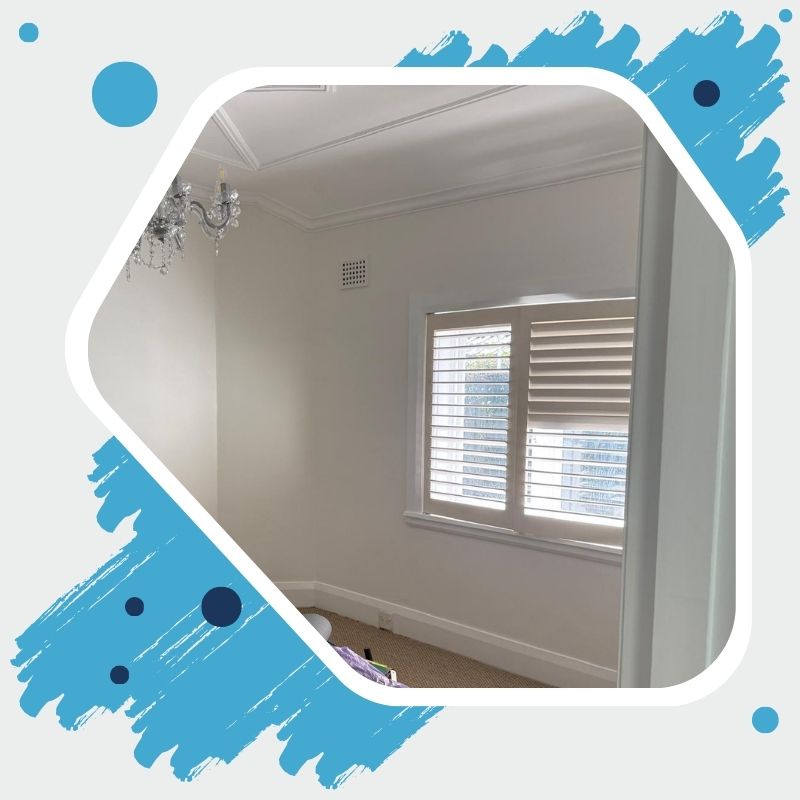 Reliable Painting Company in Sydney repainting interior walls with roller, ladder, and paint supplies in view.